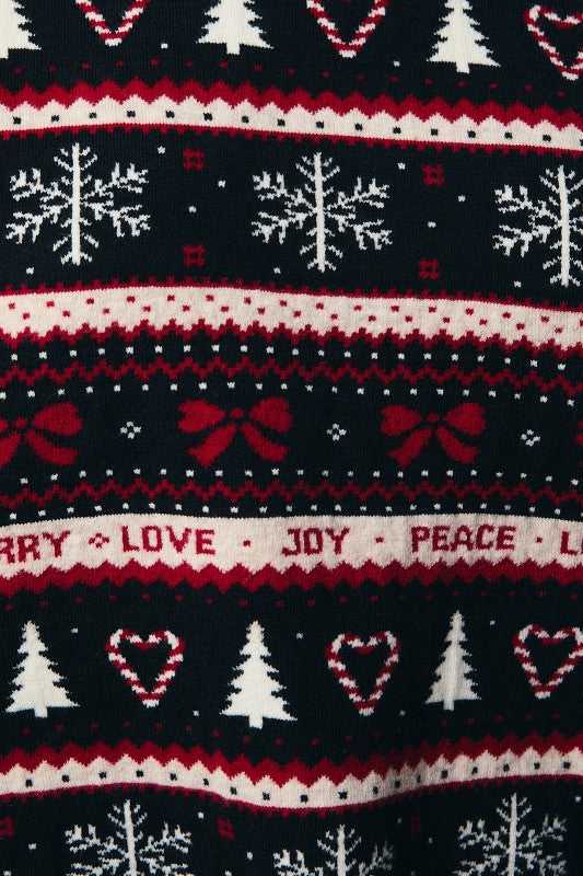 Close-up of colorful holiday design on Christmas sweater featuring bows, candy cane hearts, snow, and tree motifs