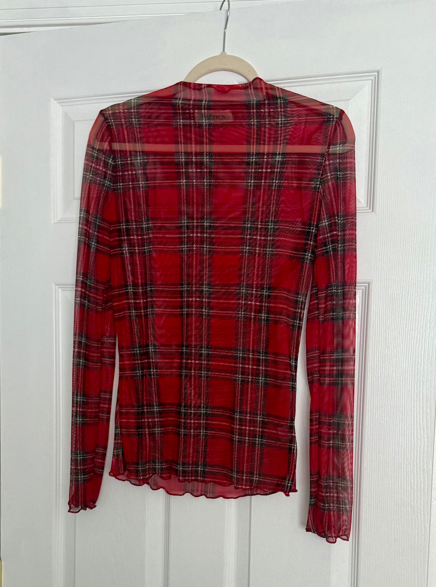 Red plaid mesh top on a hanger against a white background